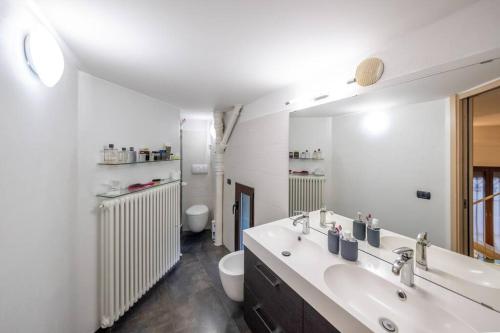 bagno con lavandino, servizi igienici e specchio di PVR Guest House a Milano