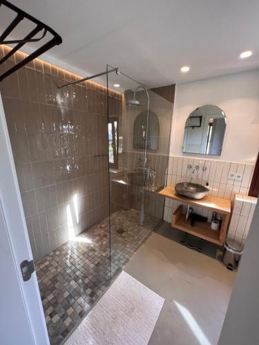 a bathroom with a shower and a sink at Los Dos Caballeros Winery & Vacation Rental in Llubí