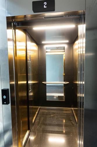 an elevator in a building with a sign on it at Royal Roi Apartments in Rovaniemi