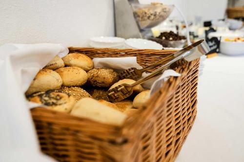 a basket filled with different types of bread and cheese at Pension Zum Hexenstieg in Schierke