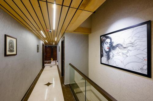 a hallway with a large painting on the wall at The Shivalik in Bhubaneshwar