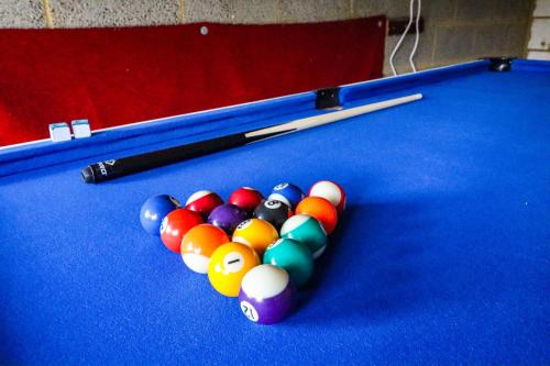 a group of billiard balls on a pool table at Emerald House - Prime Location - Free Parking, Pool Table, Fast Wifi and Sky TV by Yoko Property in Milton Keynes