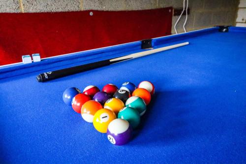 a group of billiard balls on a pool table at The Cosy House in Central MK with Free Parking, Pool Table, Fast Wifi, Smart TV and Garden by Yoko Property in Milton Keynes