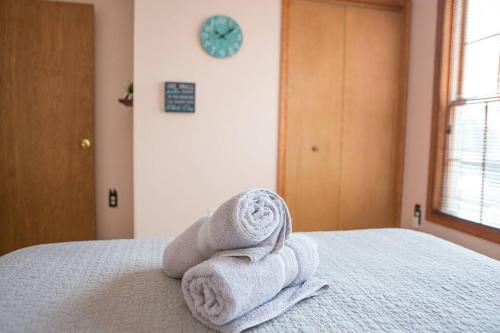 a pile of towels sitting on top of a bed at Luxury getaway in woods, Jacuzzi, Hot Tub, Pool in Bushkill