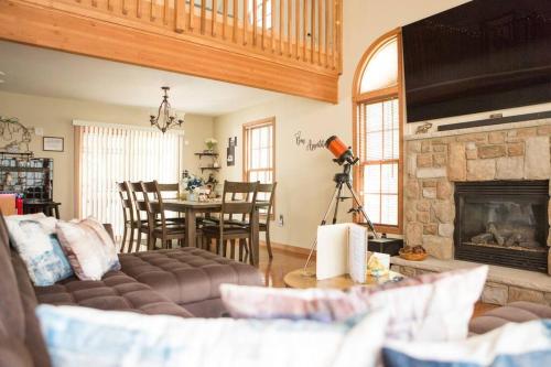 a living room with a couch and a fireplace at Luxury getaway in woods, Jacuzzi, Hot Tub, Pool in Bushkill