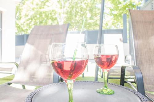 two glasses of red wine sitting on a table at Villa de lujo. Piscina con jacuzzi. in Empuriabrava