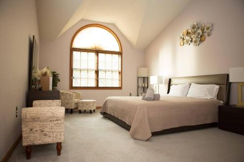 a bedroom with a large bed and a window at Luxury getaway in woods, Jacuzzi, Hot Tub, Pool in Bushkill