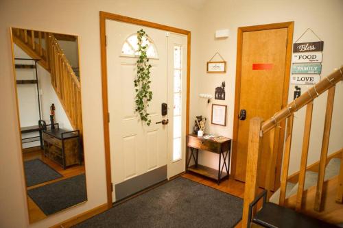a hallway with a white door with a wreath on it at Luxury getaway in woods, Jacuzzi, Hot Tub, Pool in Bushkill