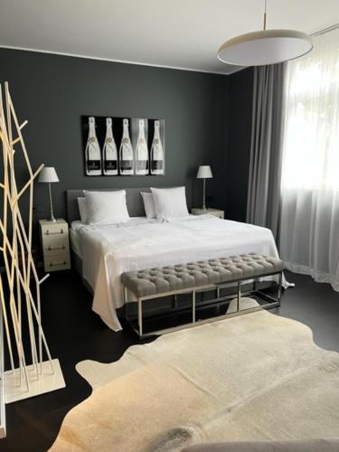 a bedroom with a large white bed and a rug at InkBlue-Apartment in Heidenau