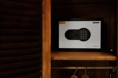 a microwave sitting on top of a wooden shelf at Moringa Ubud Villa in Ubud
