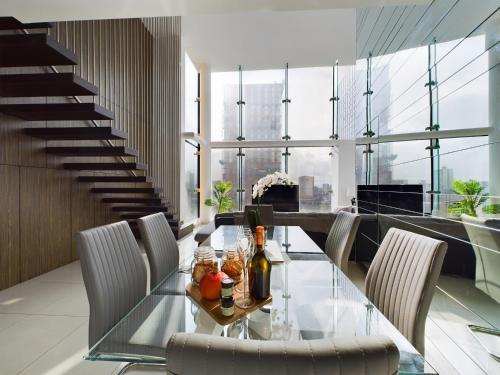 a dining room with a glass table and chairs at Amazing Skyline Views 3BR Duplex With Free Parking in Manchester