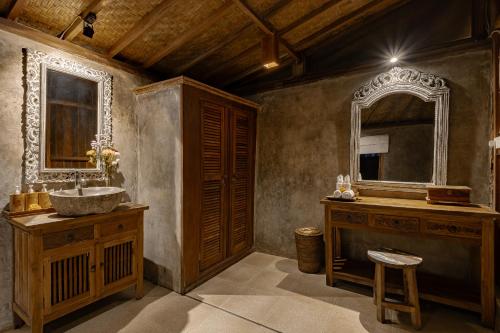 a bathroom with a sink and a mirror at Moringa Ubud Villa in Ubud