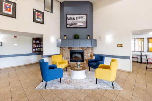 a waiting room with chairs and a fireplace at Super 8 by Wyndham Truro NS in Truro