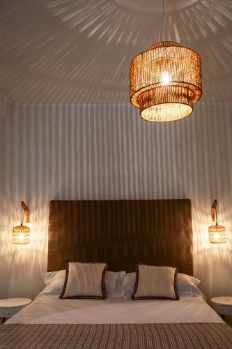 a bedroom with a large bed with two lights at Lemon Tree in Vico Equense