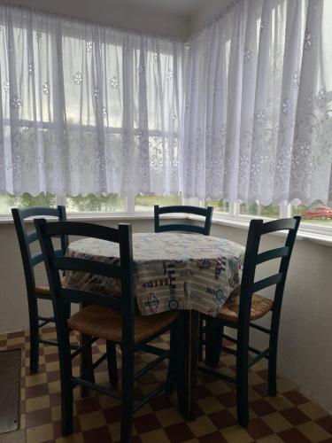 a dining room table and chairs in front of a window at Chata na Hadině - 30m od vody in Humpolec
