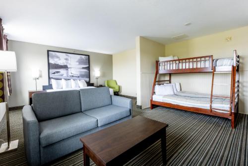 a living room with a couch and a bunk bed at Super 8 by Wyndham Truro NS in Truro
