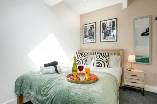a bedroom with a bed with a tray of food on it at Central Buckingham Apartment #2 with Free Parking, Pool Table, Fast Wifi and Smart TV with Netflix by Yoko Property in Buckingham