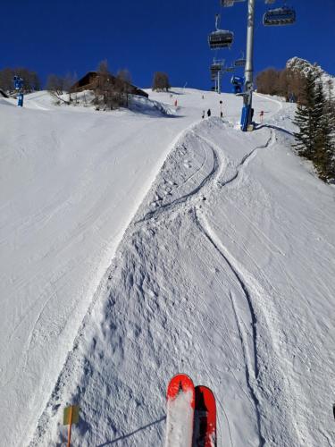 a person riding a ski lift on a snow covered slope at Haus Paul in Kals am Großglockner