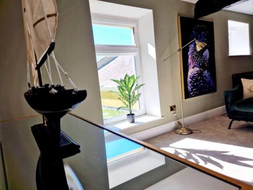 a living room with a window and a chair at Hamilton-The Cruck Luxury Let in Scorton