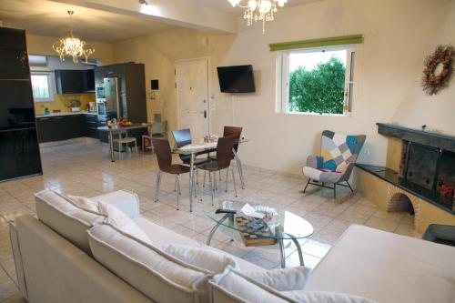 a living room with a couch and a table at House with sea breeze-Anemelia in Nafplio