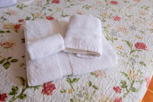 two towels sitting on top of a bed at Emily's House in Arcos de Valdevez