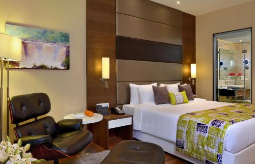 a hotel room with a bed and a table and chairs at Fortune Park Dahej - Member ITC Hotels' Group in Dahej
