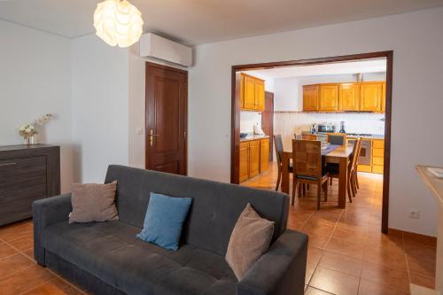 a living room with a couch and a dining room at Emily's House in Arcos de Valdevez
