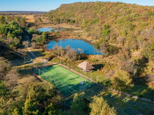 an overhead view of a tennis court and a lake at Waterberg Game Park in Mokopane