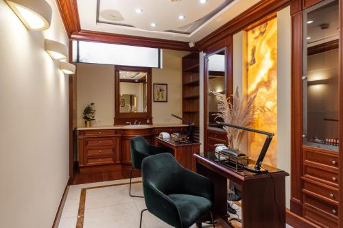 a bathroom with a vanity and two chairs and a desk at Hotel Haffner Resort & Spa - Destigo Hotels in Sopot