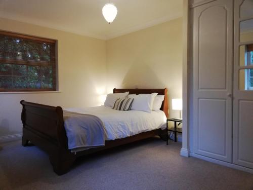 a bedroom with a bed with white sheets and a window at Brand New 2 bed in one of Newbury oldest buildings in Newbury