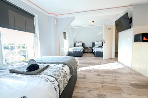 a bedroom with two beds and a large window at Happy -Apartments in Magdeburg