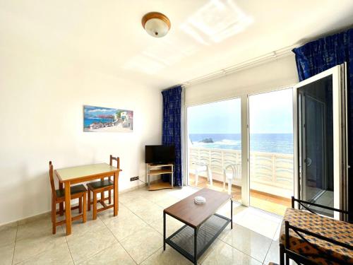 a living room with a view of the ocean at Apt next to the Atlantic Ocean, with unbeatable views in Tamaduste