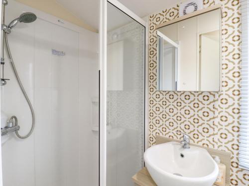 a white bathroom with a sink and a mirror at Number 54 in Stowmarket