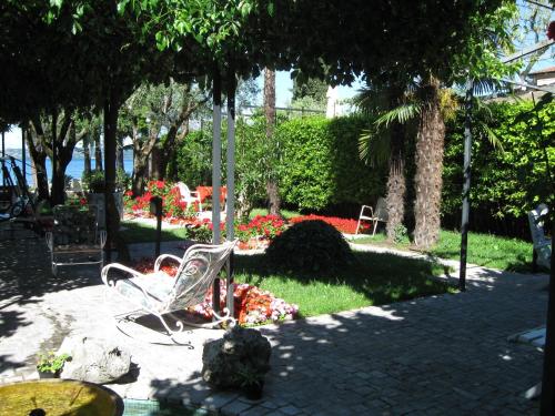a person laying in a chair in a park at Hotel Giardino in Sirmione