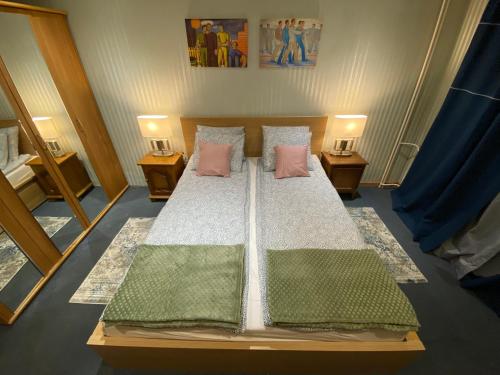 a bedroom with a large bed with two night stands at Apartament Dyrektorski in Stalowa Wola