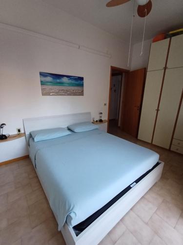 um quarto com uma grande cama branca num quarto em Home Mariarita em Montesilvano