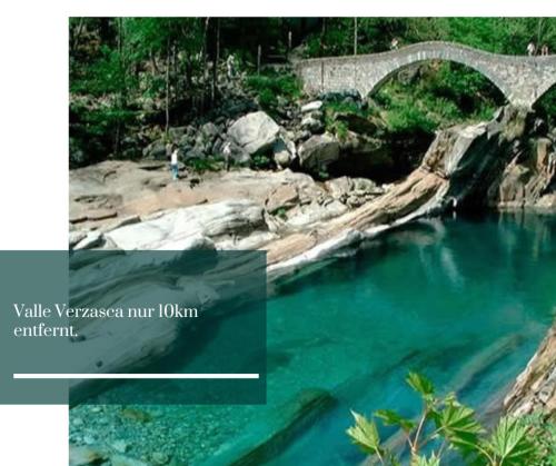 a bridge over a river with blue water at Traum Ferienwohnung am Strand im Tessin - nur 3km von Ascona oder Locarno entfernt in Tegna