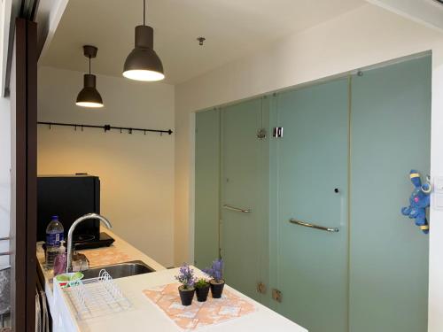 a kitchen with a sink and a large green cabinet at Cozy Skyview DillaSuite-Trefoil (Wifi,Pool,Netflix) in Shah Alam