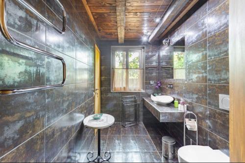 a bathroom with two sinks and two toilets at Turdus Merula Retreat in Nea Makri
