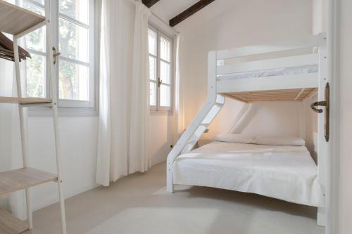 a bedroom with a bunk bed and two windows at Charming loft in Venetian Villa in Noale