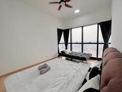 a bedroom with a bed and a couch and a window at Family Gathering with Bathtub in Icon City, 12 Pax near Bandar Sunway in Petaling Jaya
