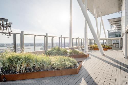 a balcony of a building with plants on it at Fabulous Morden Apartment in Helsinki in Helsinki