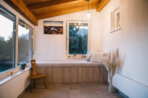 a room with a window with a bench in front of it at Vikendica Jure Blidinje Ski&Nature in Čuljci