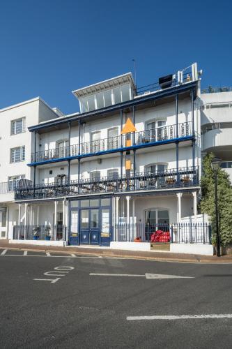 a large white building with balconies and a street at Royal London Yacht Club in West Cowes