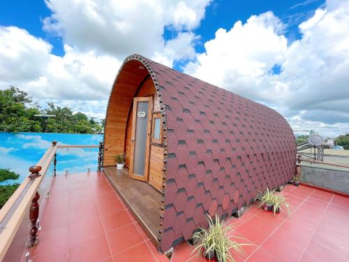 a tiny house with a roof that looks like a snake at Homestay Lê Gia in Xuyên Mộc