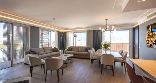 a living room with a couch and a table and chairs at Ceccarini 9 home suite home in Riccione