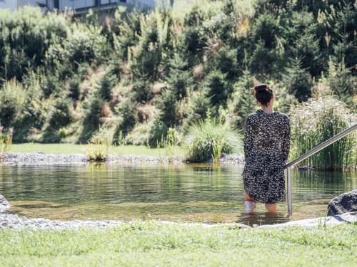 a woman standing in a body of water at Apartment Greta by Interhome in Stams