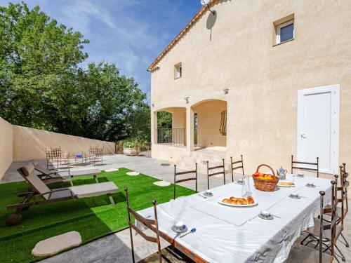 a patio with a table and chairs in a yard at Holiday Home Malanuit by Interhome in Bauduen