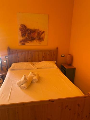 a bedroom with a bed with a towel on it at Lo Scoiattolo Country House in Montorio al Vomano