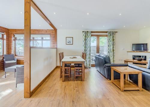 a living room with a couch and a table at Heart Of Wales Lodges in Penybont